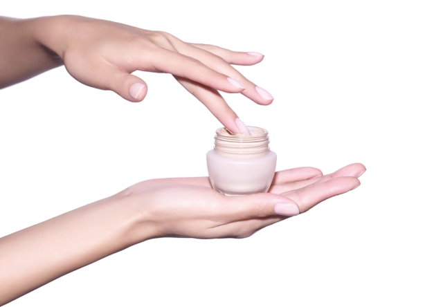 Woman's hands holding a tinted moisturizer