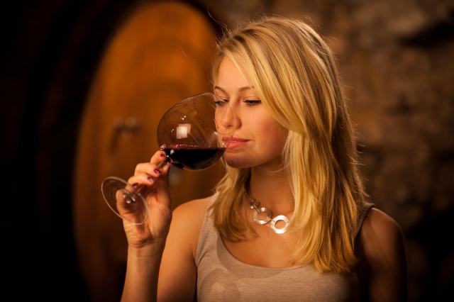 Woman sipping wine from a glass. 